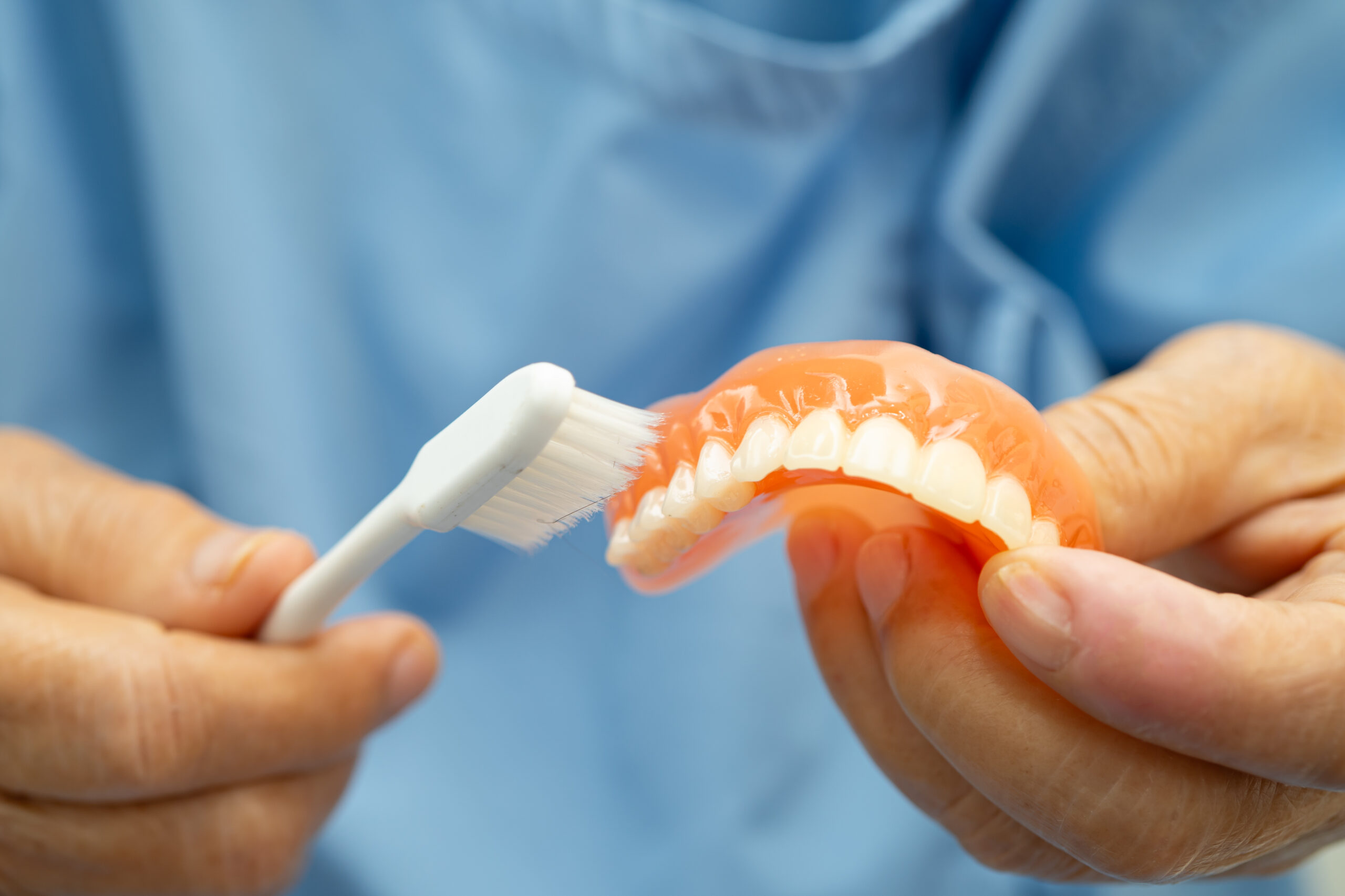 Asian elderly woman patient holding to use denture, healthy stro